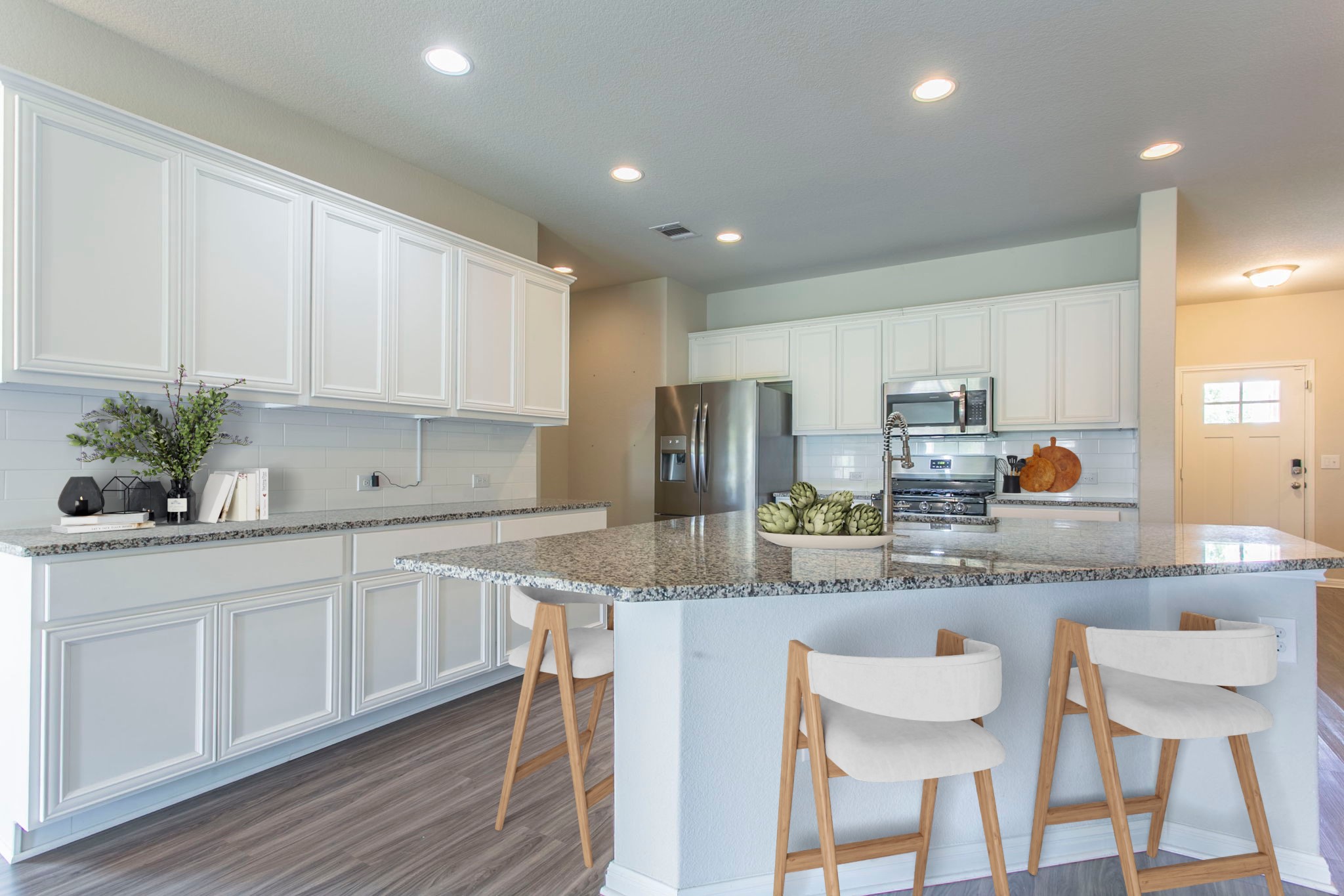 313 Bremen Street Georgetown, TX 78626 - Photo 1 of 1 a kitchen with stainless steel appliances granite countertop white cabinets a sink and chairs