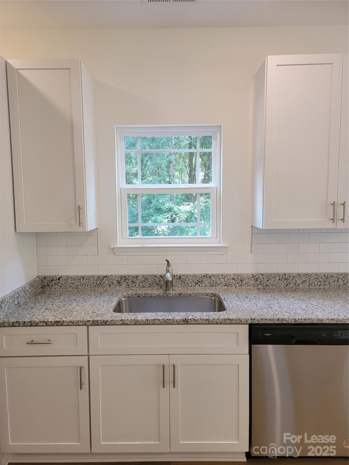 Undisclosed Address Waxhaw, NC 28173 - Photo 11 of 22 a kitchen with granite countertop white cabinets and a granite counter tops
