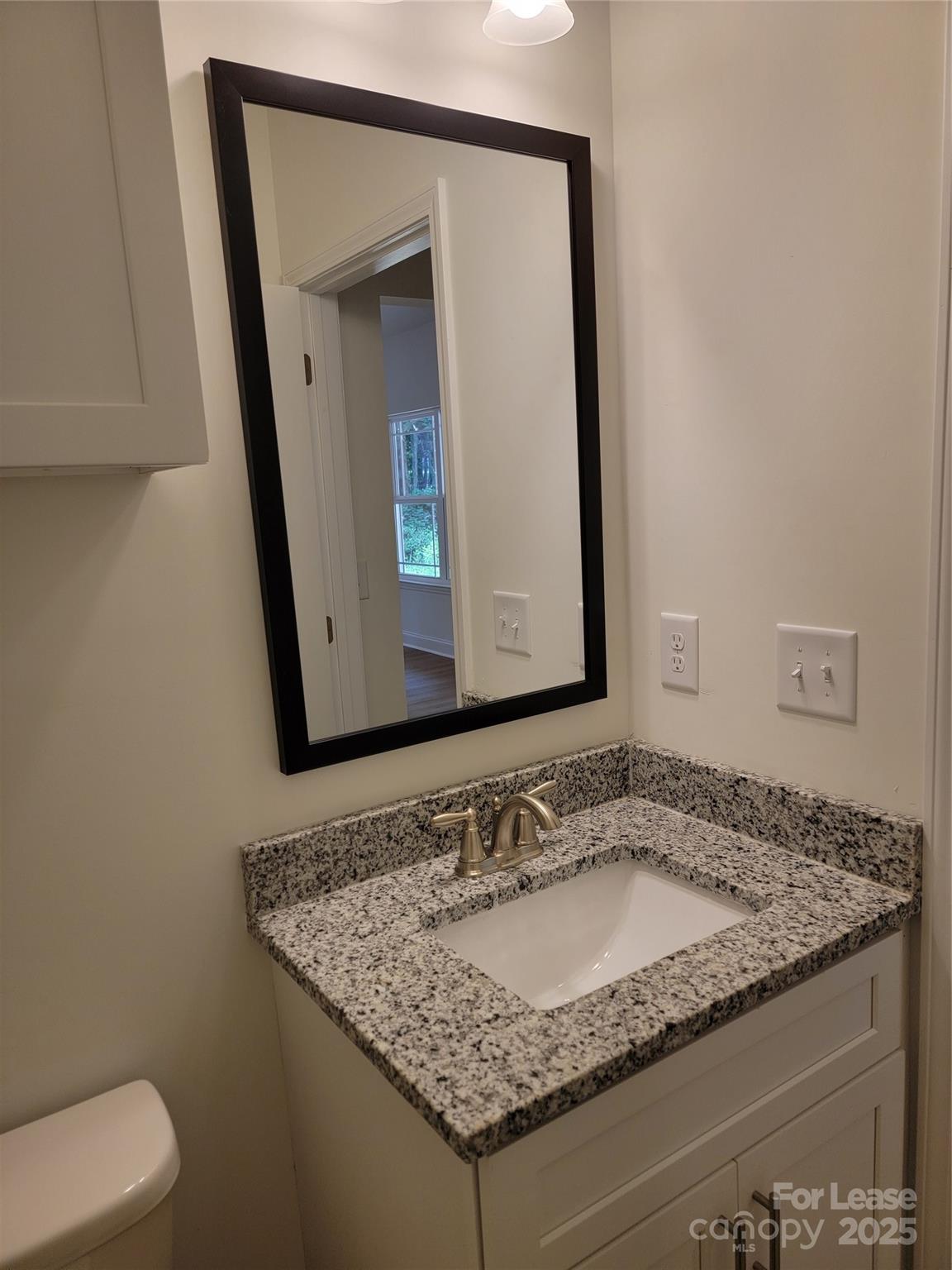 Undisclosed Address Waxhaw, NC 28173 - Photo 17 of 22 a bathroom with a granite countertop sink and a mirror