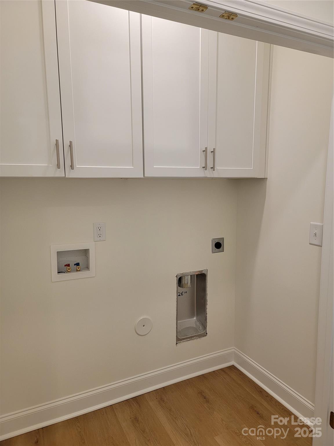 Undisclosed Address Waxhaw, NC 28173 - Photo 19 of 22 a view of an empty room with wooden floor and cabinet