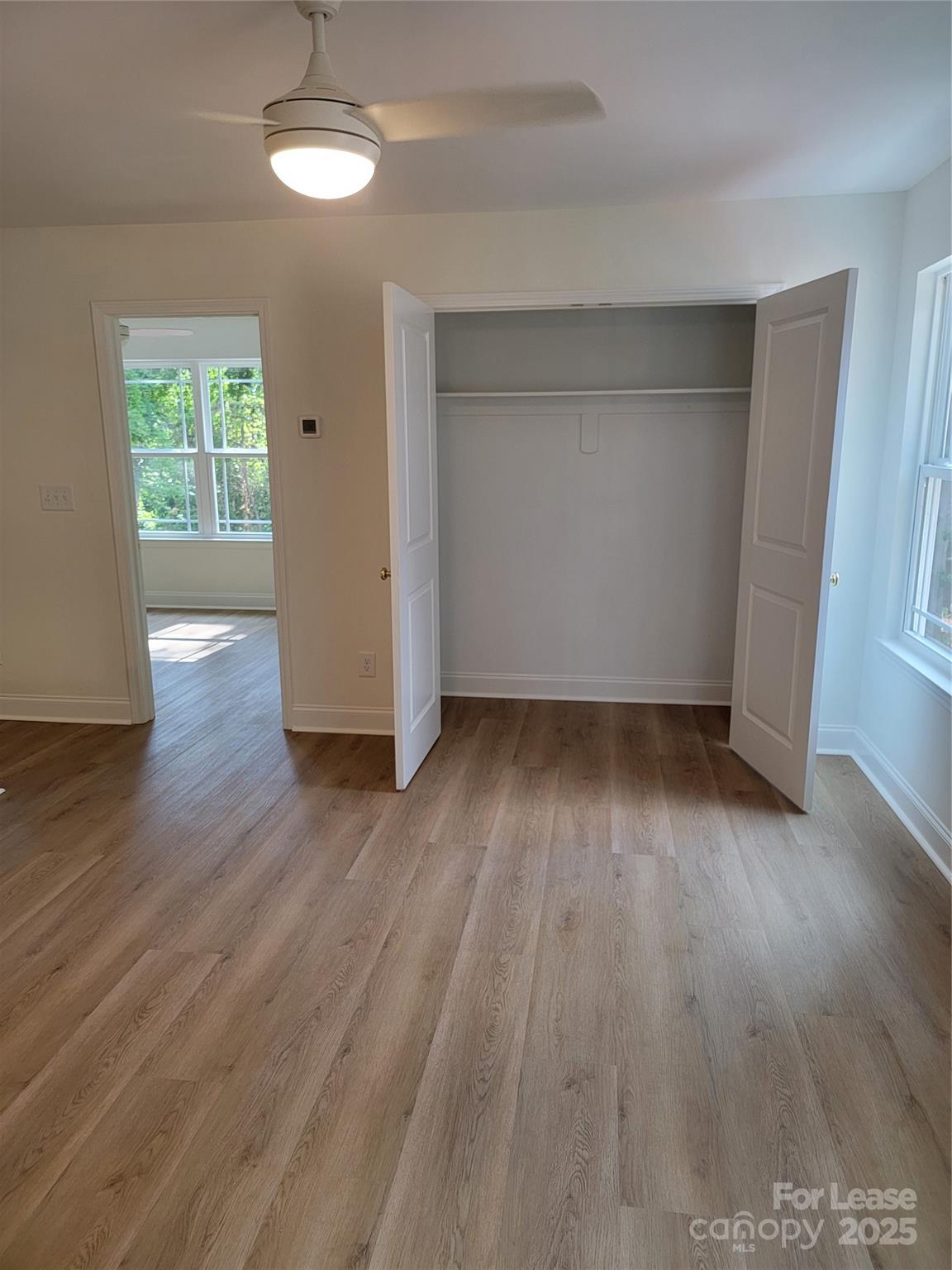 Undisclosed Address Waxhaw, NC 28173 - Photo 20 of 22 an empty room with wooden floor and windows