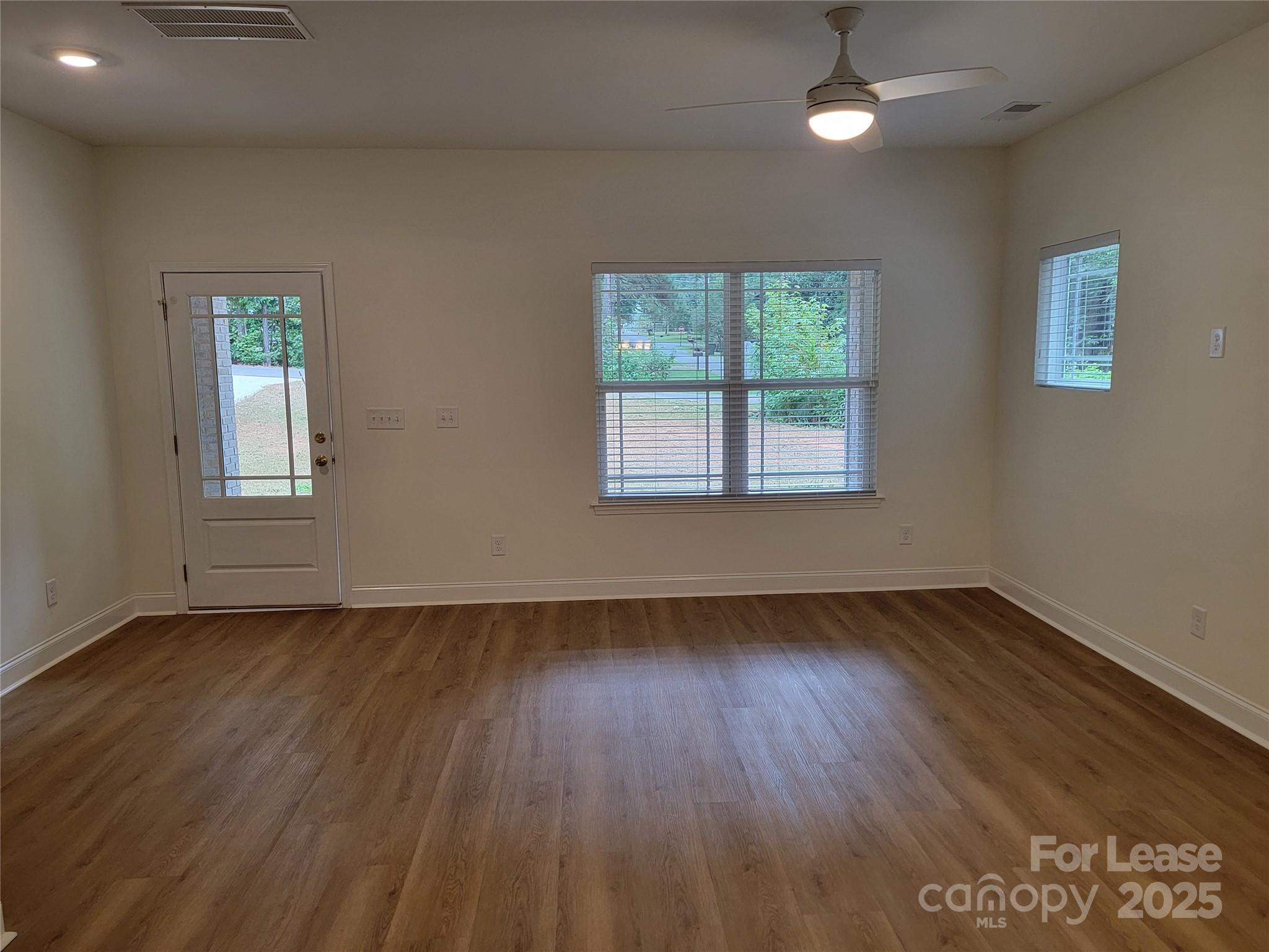 Undisclosed Address Waxhaw, NC 28173 - Photo 21 of 22 a view of an empty room with wooden floor and a window