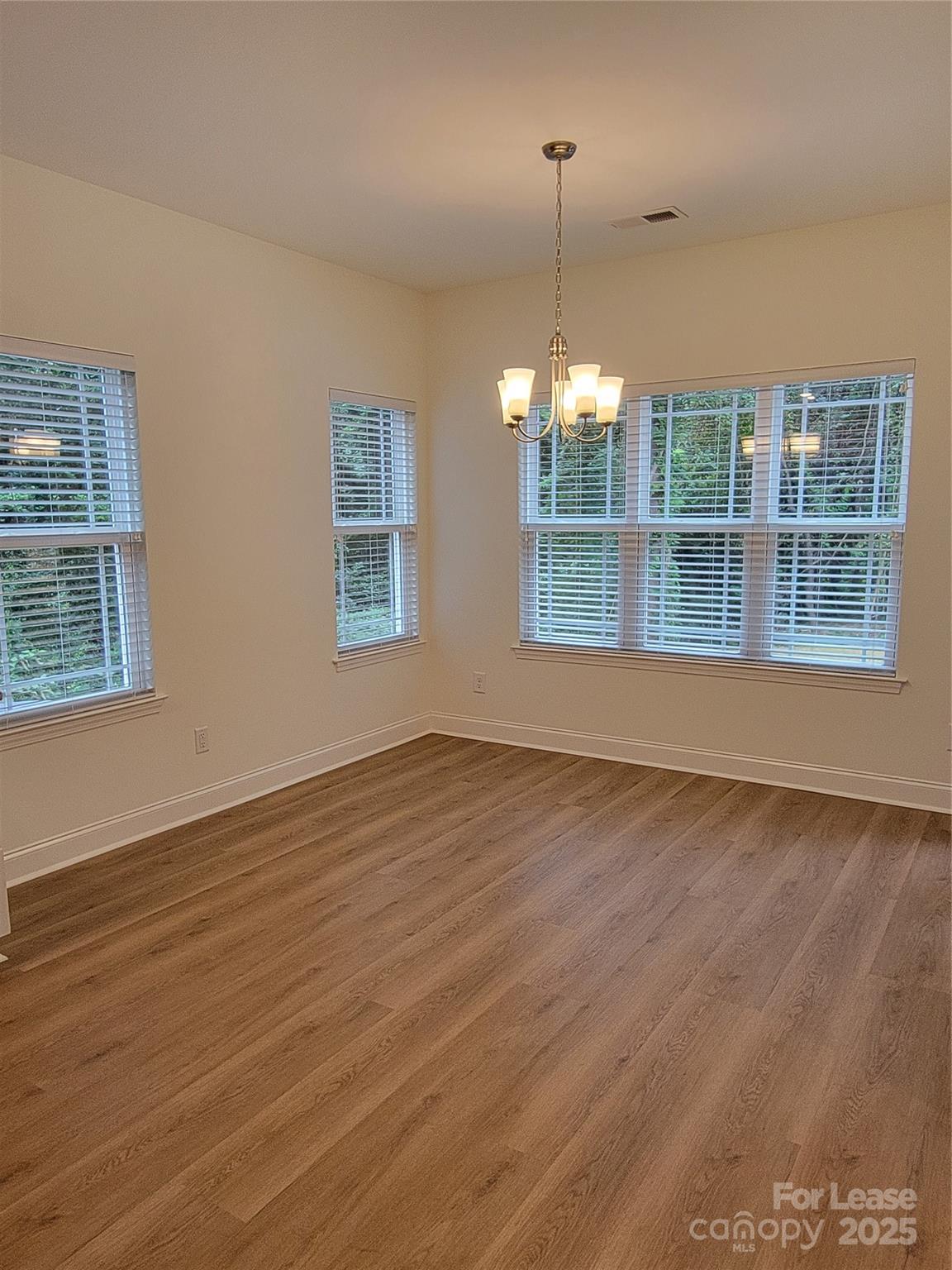 Undisclosed Address Waxhaw, NC 28173 - Photo 22 of 22 a view of an empty room with wooden floor and a window