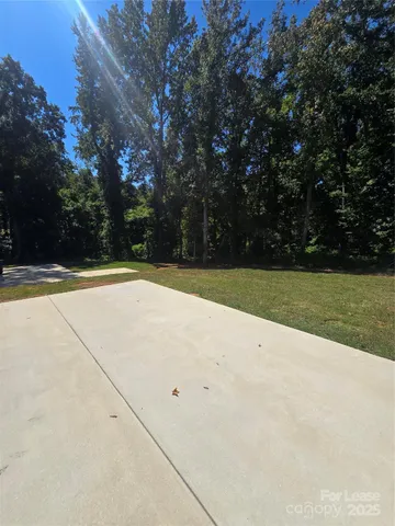 a view of a swimming pool and trees in the background