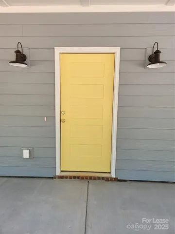 a large kitchen with stainless steel appliances granite countertop a large counter top a sink and a refrigerator