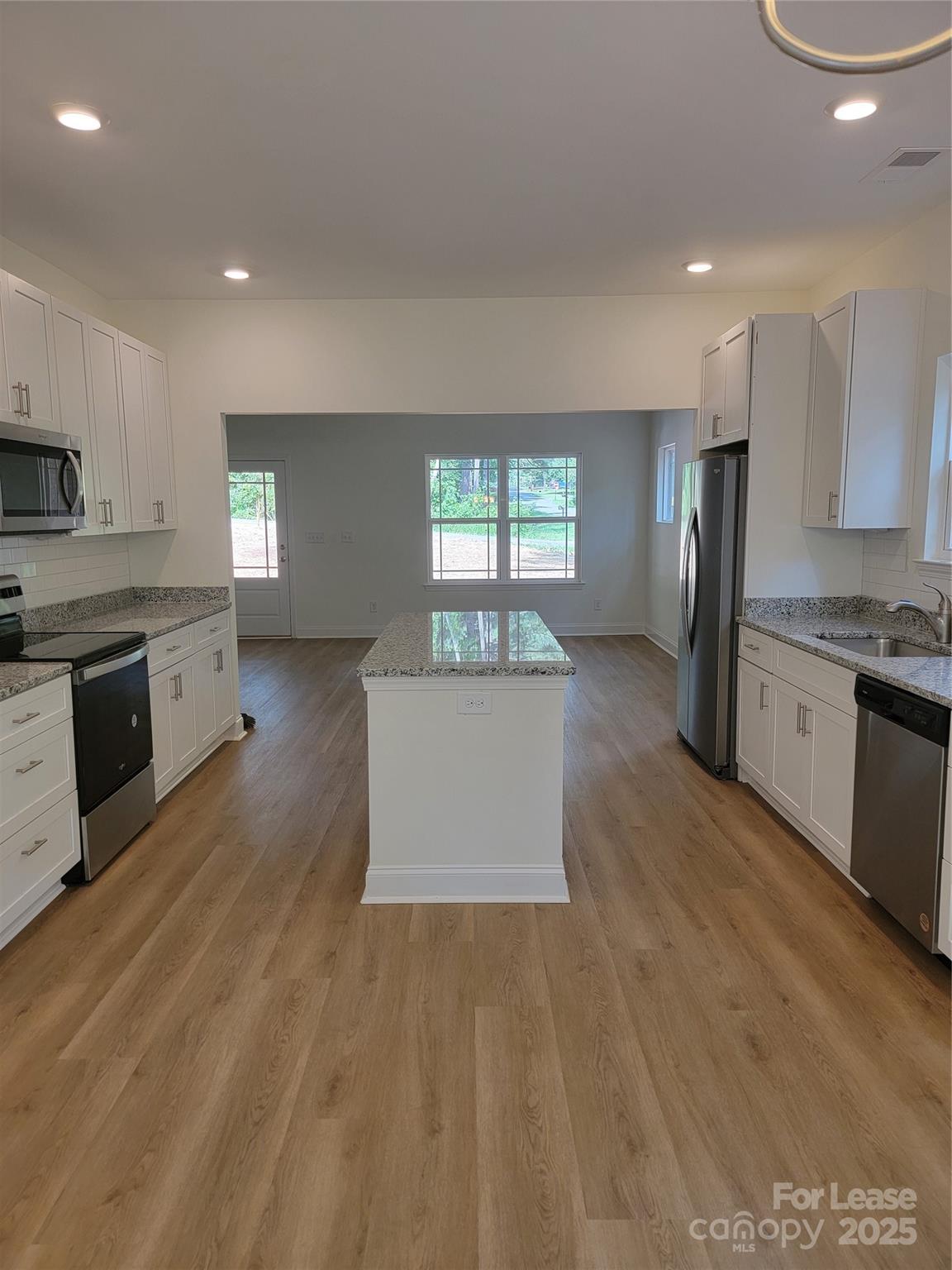 Undisclosed Address Waxhaw, NC 28173 - Photo 7 of 22 a large kitchen with stainless steel appliances granite countertop a large counter top a sink and a refrigerator