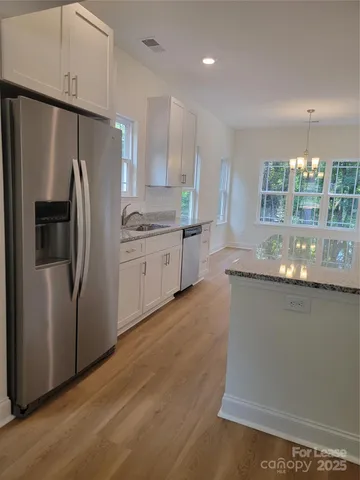a kitchen with stainless steel appliances granite countertop a stove a sink and a granite counter tops