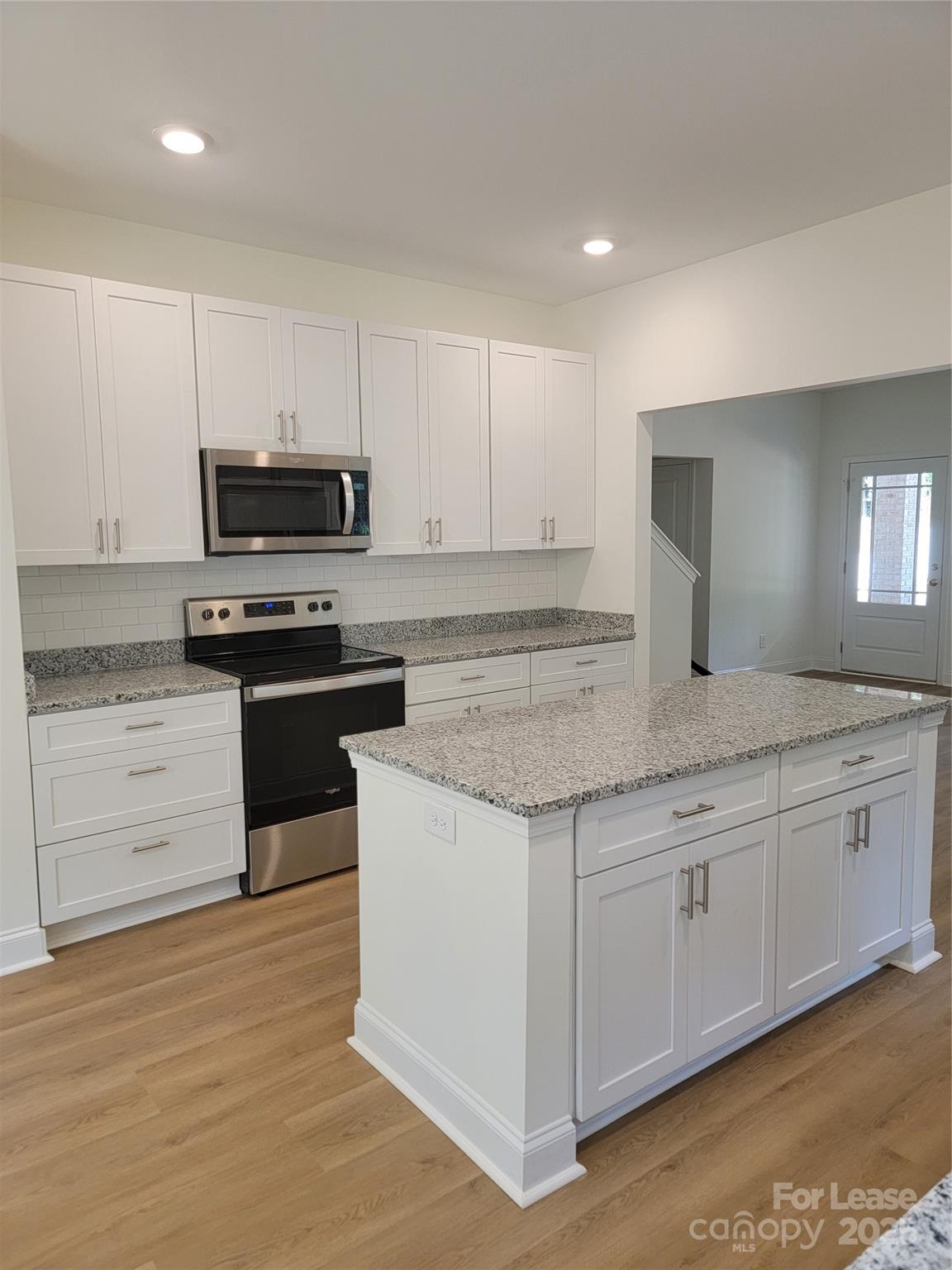 Undisclosed Address Waxhaw, NC 28173 - Photo 9 of 22 a kitchen with stainless steel appliances granite countertop a stove a sink and a granite counter tops