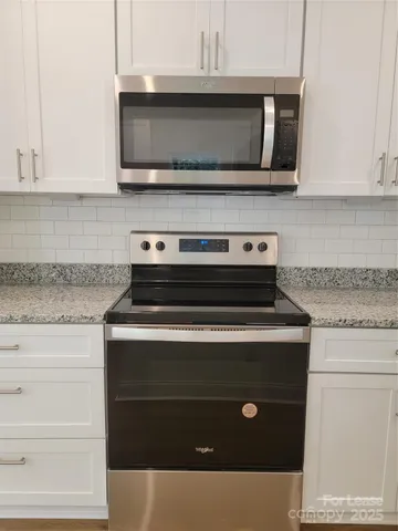 a kitchen with granite countertop white cabinets and a granite counter tops