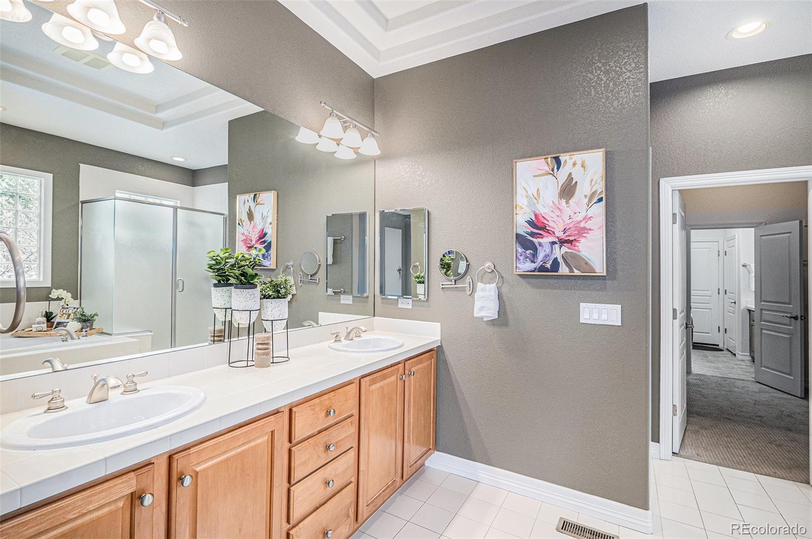 529 Uinta Way Denver, CO 80230 - Photo 11 of 37 a bathroom with a double vanity sink and a mirror