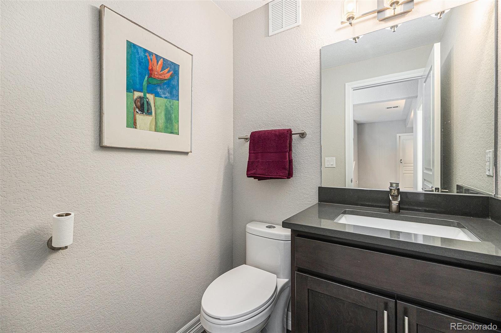 529 Uinta Way Denver, CO 80230 - Photo 18 of 37 a bathroom with a toilet sink and mirror
