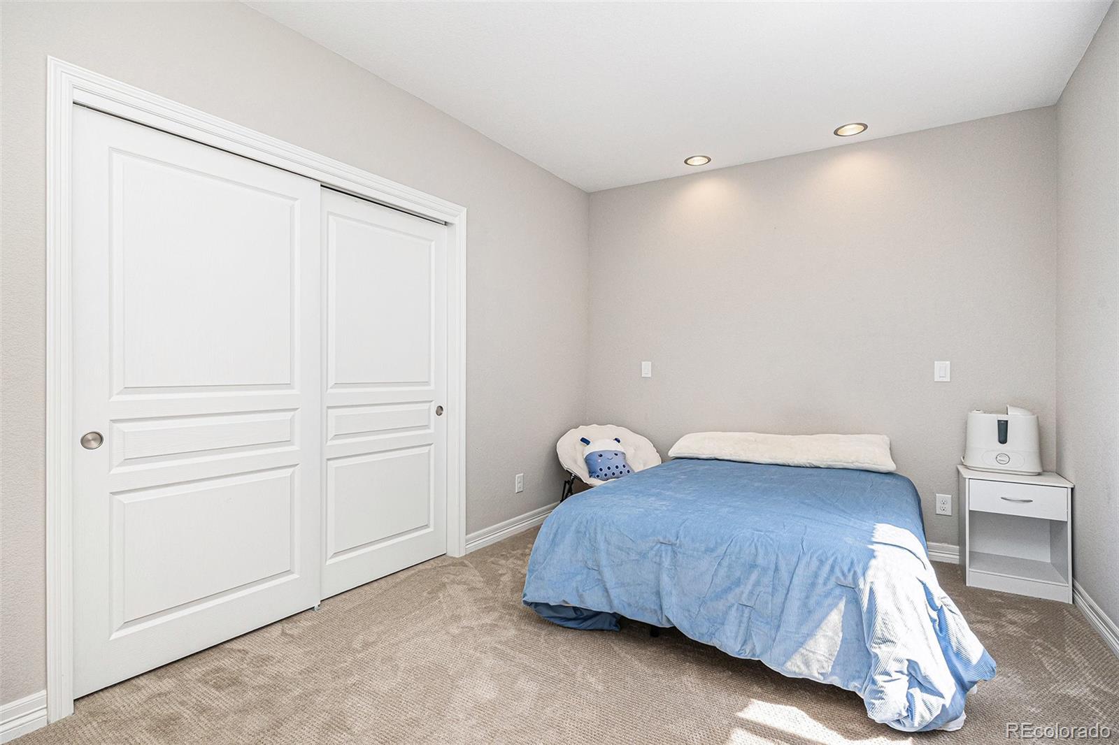 529 Uinta Way Denver, CO 80230 - Photo 21 of 37 a bedroom with a bed and cabinet