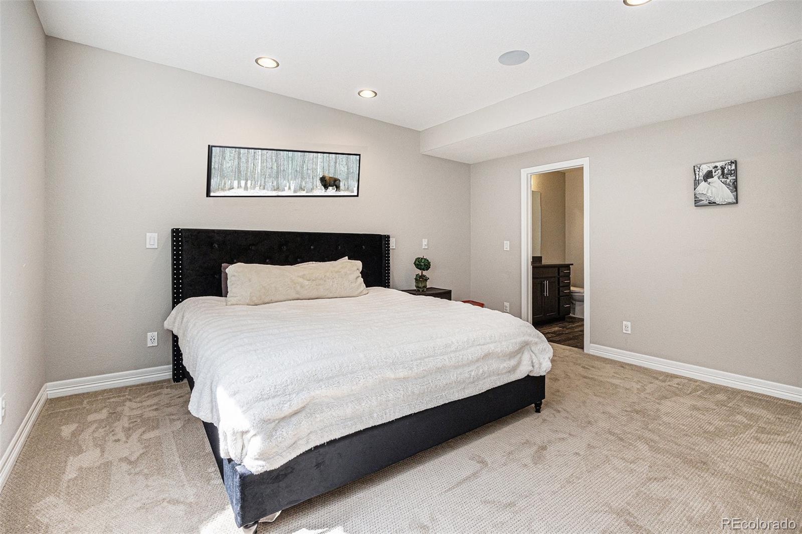 529 Uinta Way Denver, CO 80230 - Photo 22 of 37 a bedroom with a bed and painting on the wall