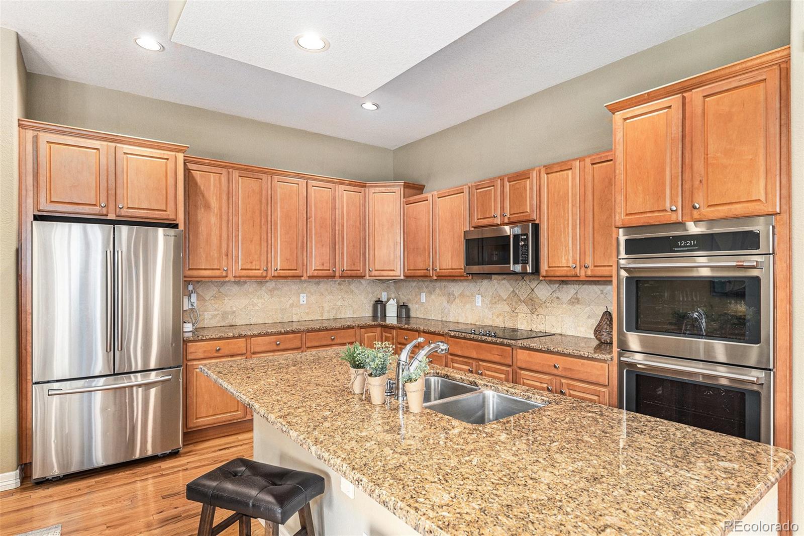 529 Uinta Way Denver, CO 80230 - Photo 7 of 37 a kitchen with granite countertop a refrigerator and a sink