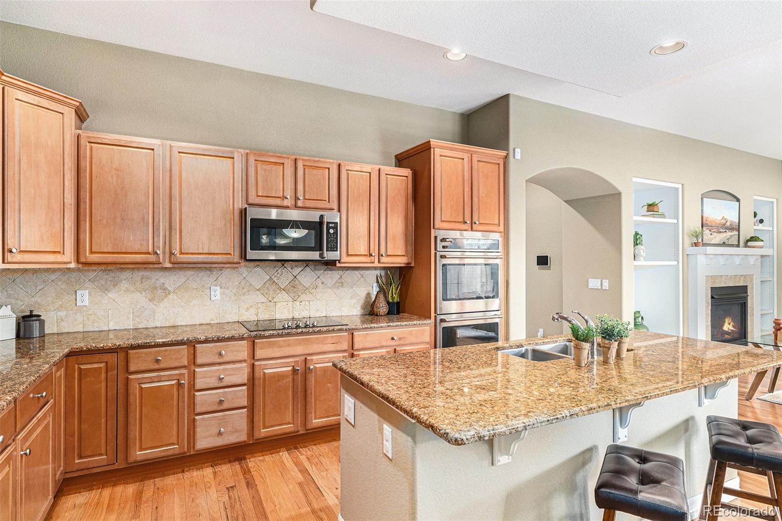 529 Uinta Way Denver, CO 80230 - Photo 8 of 37 a kitchen with stainless steel appliances granite countertop a sink dishwasher and a microwave oven with white cabinets