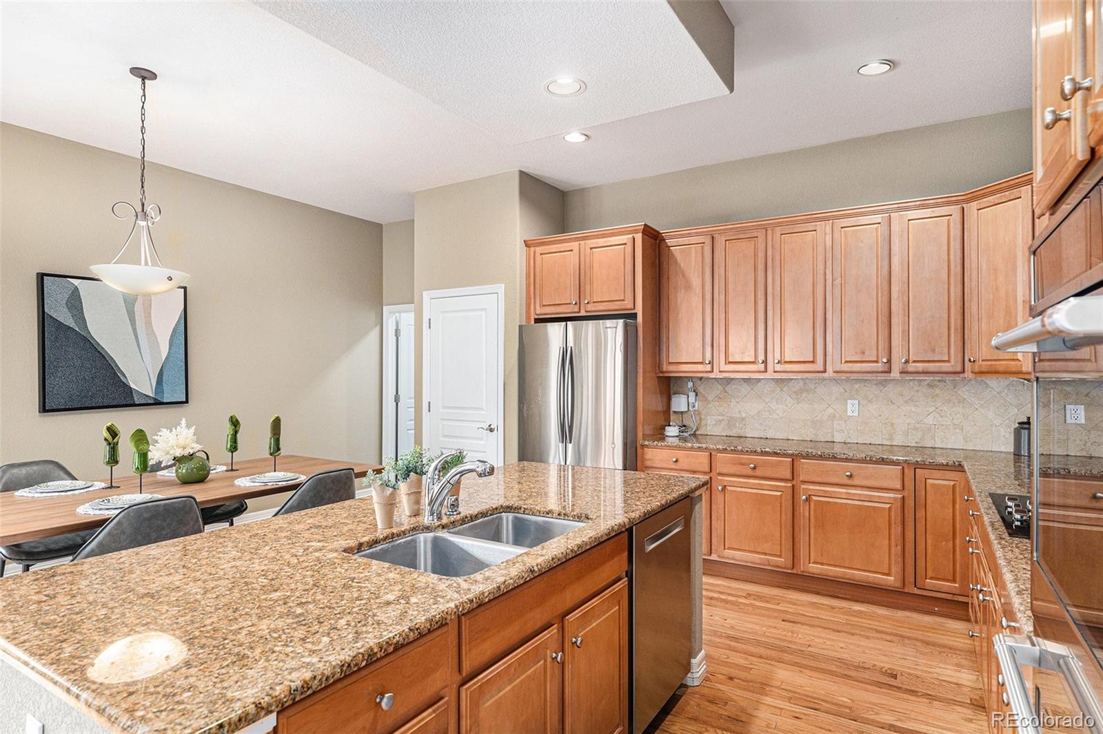 529 Uinta Way Denver, CO 80230 - Photo 9 of 37 a kitchen with stainless steel appliances granite countertop a sink a stove and a refrigerator