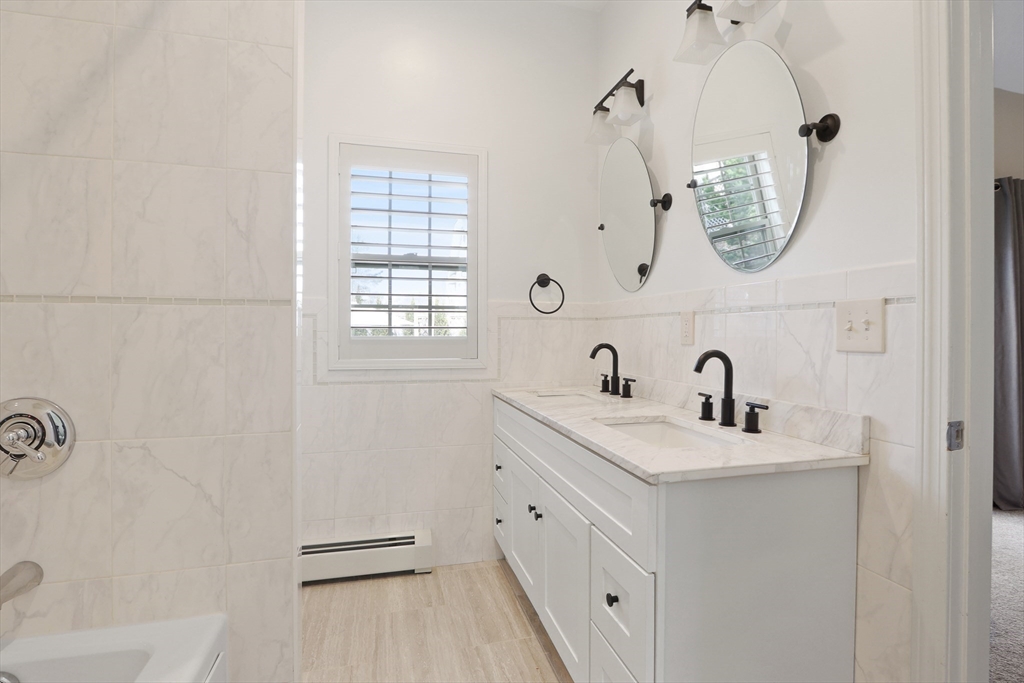 96 Brantwood Road Worcester, MA 01602 - Photo 16 of 33 a bathroom with a double vanity sink window and mirror