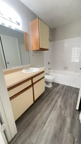 a bathroom with a sink a toilet and mirror