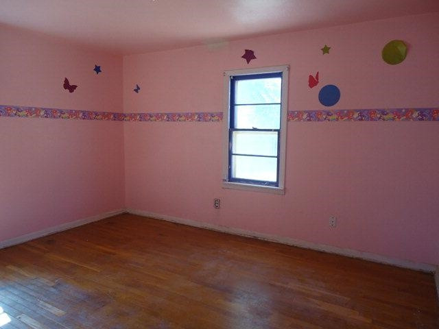 206 16th Street Levelland, TX 79336 - Photo 5 of 8 an empty room with windows