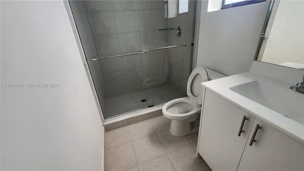 a white toilet sitting next to a bathroom sink