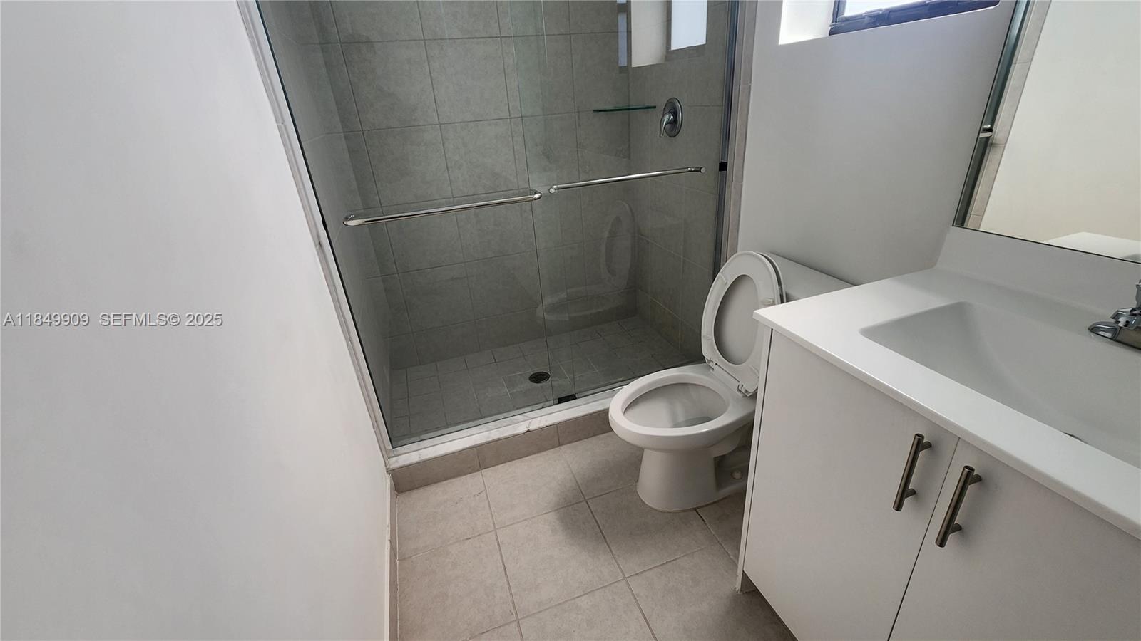 12897 Southwest 234th Street, Unit 12897 Homestead, FL 33032 - Photo 11 of 24 a white toilet sitting next to a bathroom sink