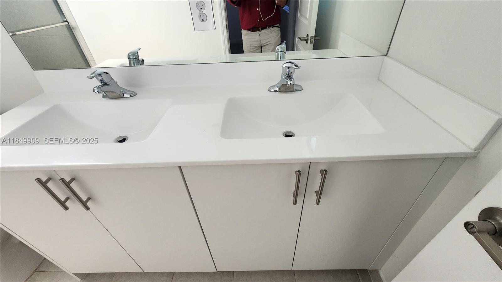 12897 Southwest 234th Street, Unit 12897 Homestead, FL 33032 - Photo 12 of 24 a bathroom with a sink and a mirror
