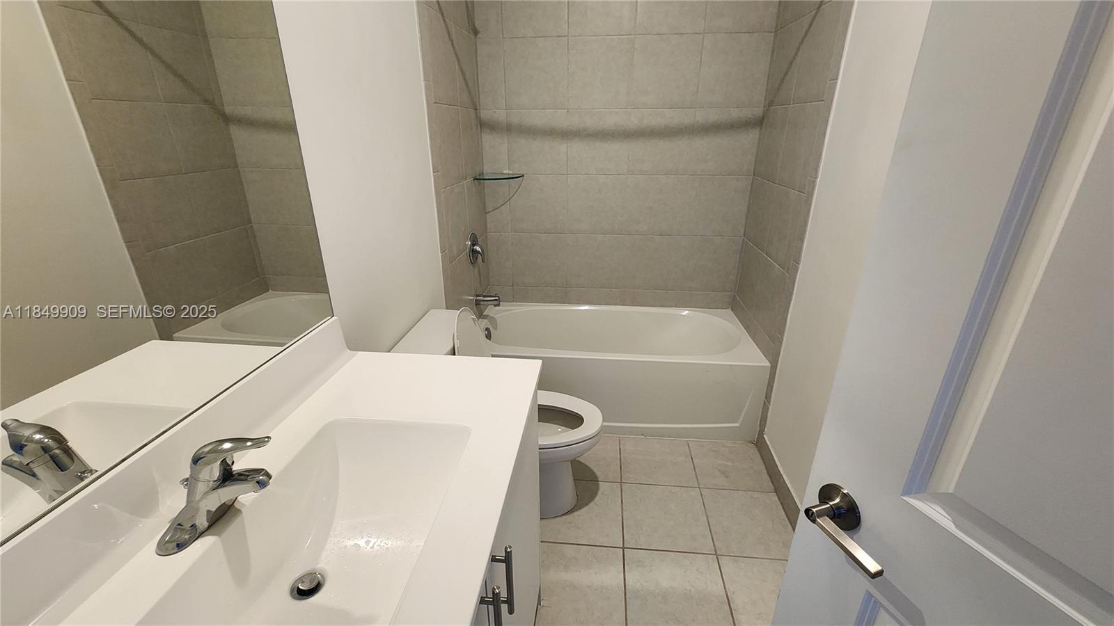 12897 Southwest 234th Street, Unit 12897 Homestead, FL 33032 - Photo 17 of 24 a bathroom with a bathtub