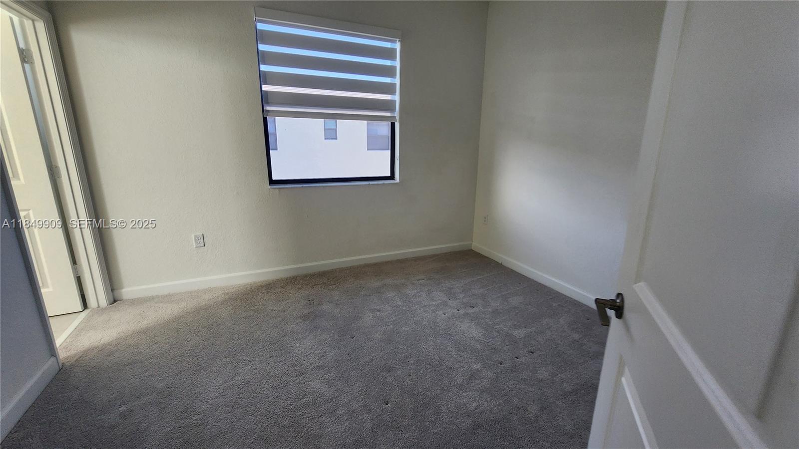 12897 Southwest 234th Street, Unit 12897 Homestead, FL 33032 - Photo 21 of 24 a view of empty room with window