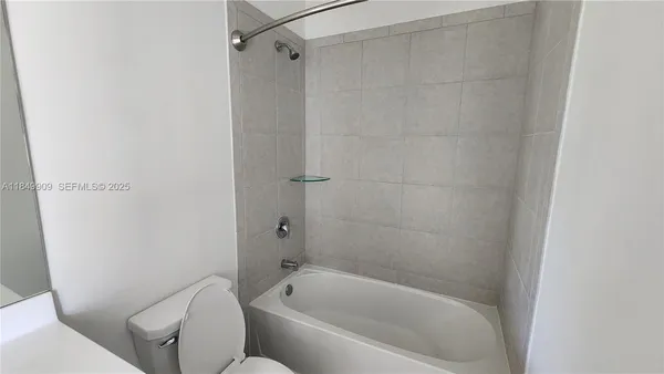 a bathroom with a bathtub and a toilet
