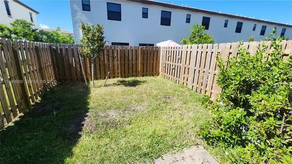 a view of a house with wooden fence