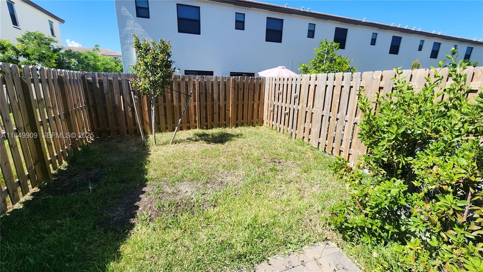 12897 Southwest 234th Street, Unit 12897 Homestead, FL 33032 - Photo 8 of 24 a view of a house with wooden fence