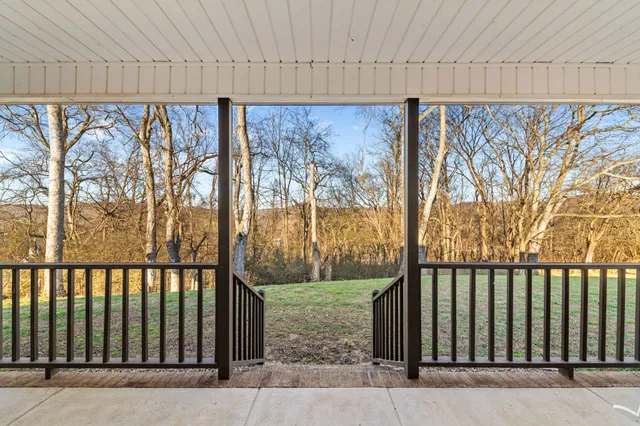 a living room with furniture a dining table and chairs with wooden floor