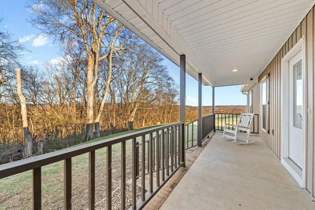a view of a dining room with furniture and a chandelier