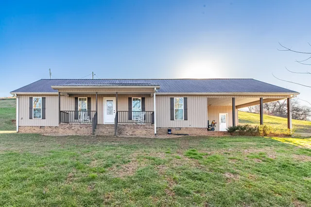 a front view of house with yard and porch