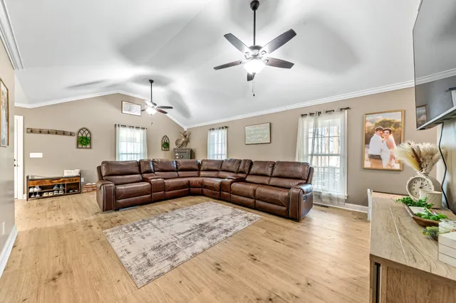 a kitchen with stainless steel appliances granite countertop a stove a sink a dining table and chairs