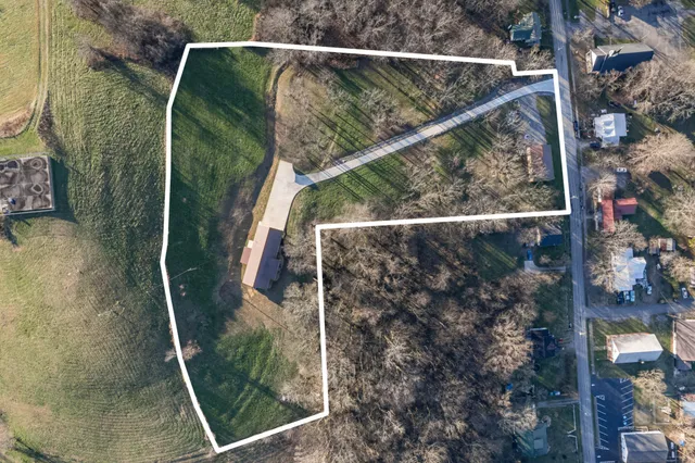 a house with green field in front of it