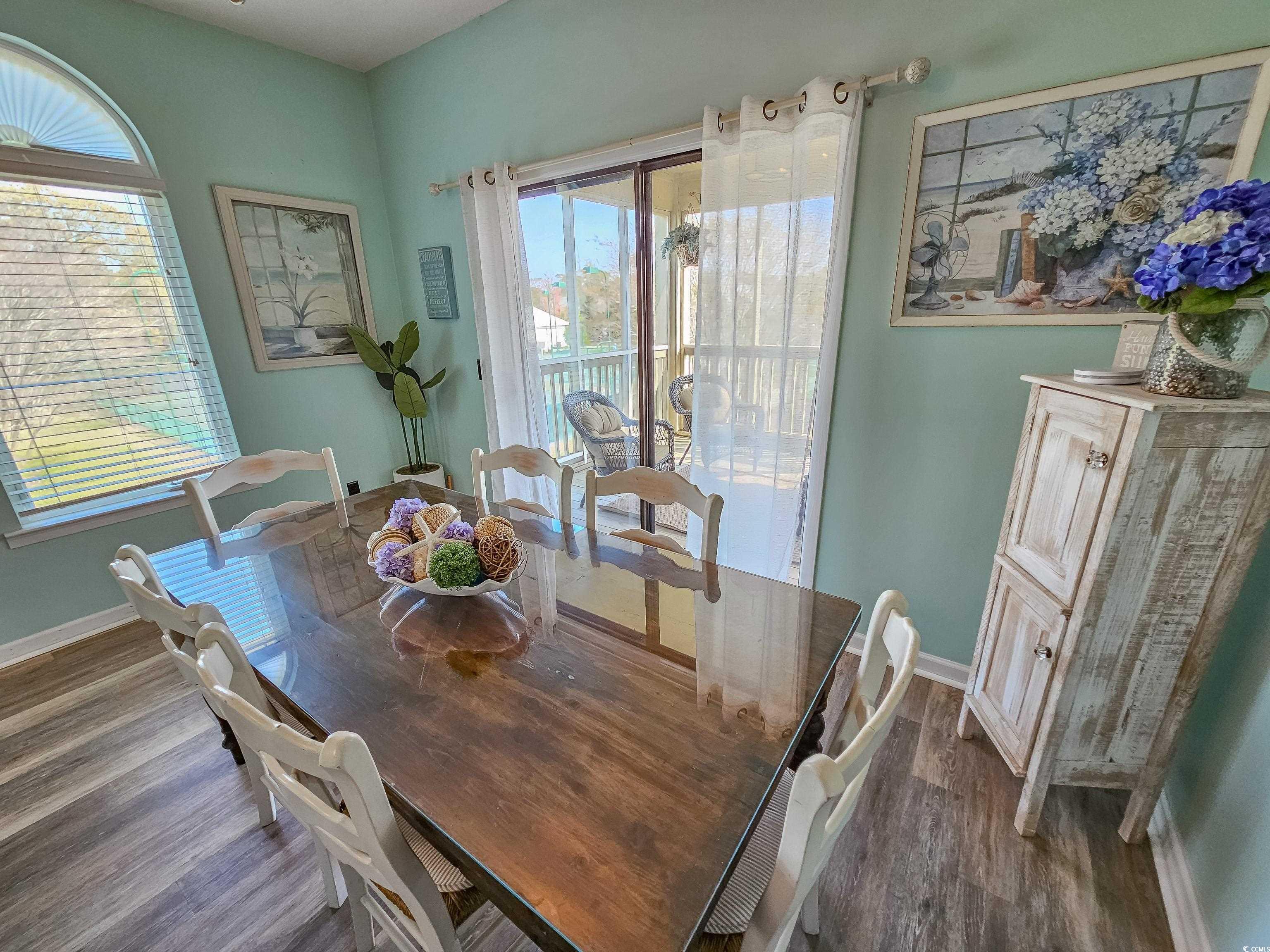 800 Castleford Circle, Unit 1E Myrtle Beach, SC 29572 - Photo 14 of 40 Dining room featuring dark wood-style floors and baseboards