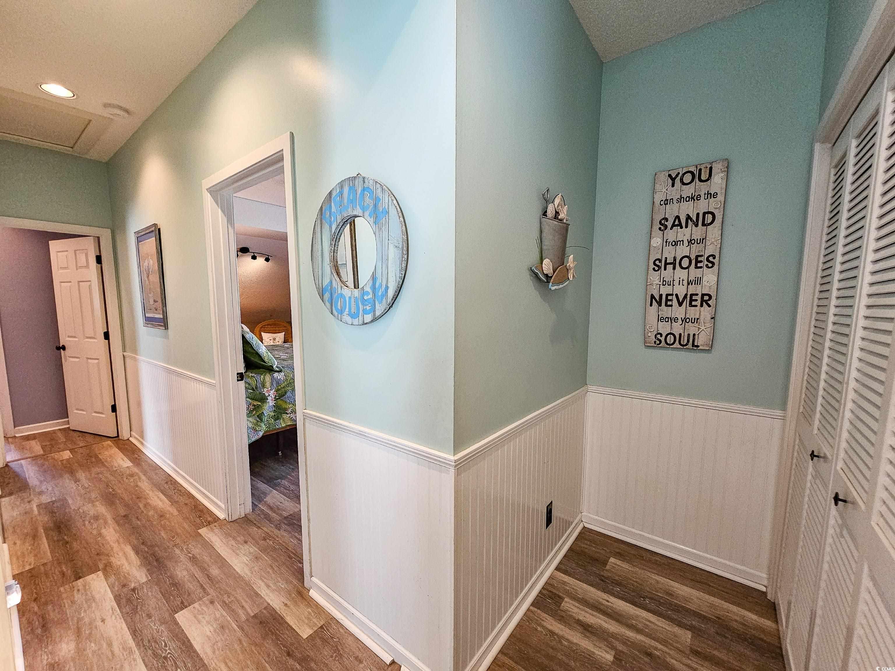 800 Castleford Circle, Unit 1E Myrtle Beach, SC 29572 - Photo 18 of 40 Hall with wood finished floors, attic access, and wainscoting
