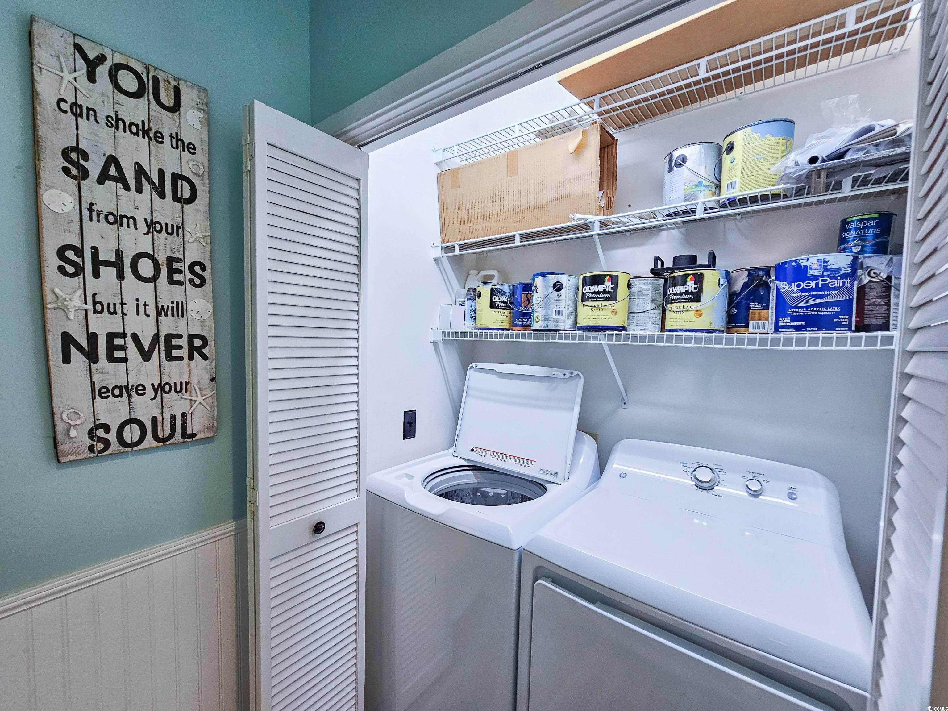 800 Castleford Circle, Unit 1E Myrtle Beach, SC 29572 - Photo 19 of 40 Laundry room with washing machine and clothes dryer, a wainscoted wall, and laundry area