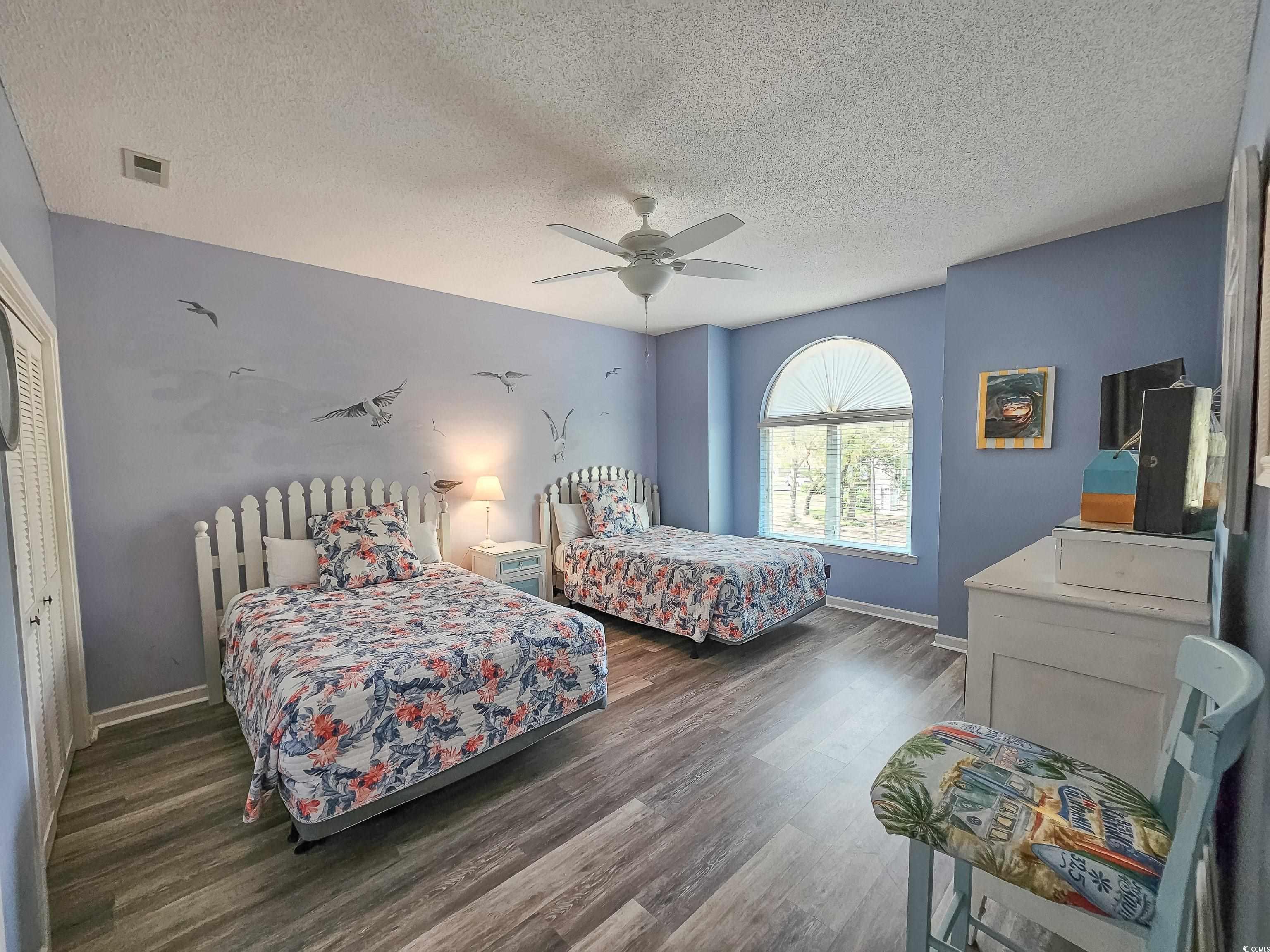 800 Castleford Circle, Unit 1E Myrtle Beach, SC 29572 - Photo 21 of 40 Bedroom featuring wood finished floors, baseboards, ceiling fan, and visible vents
