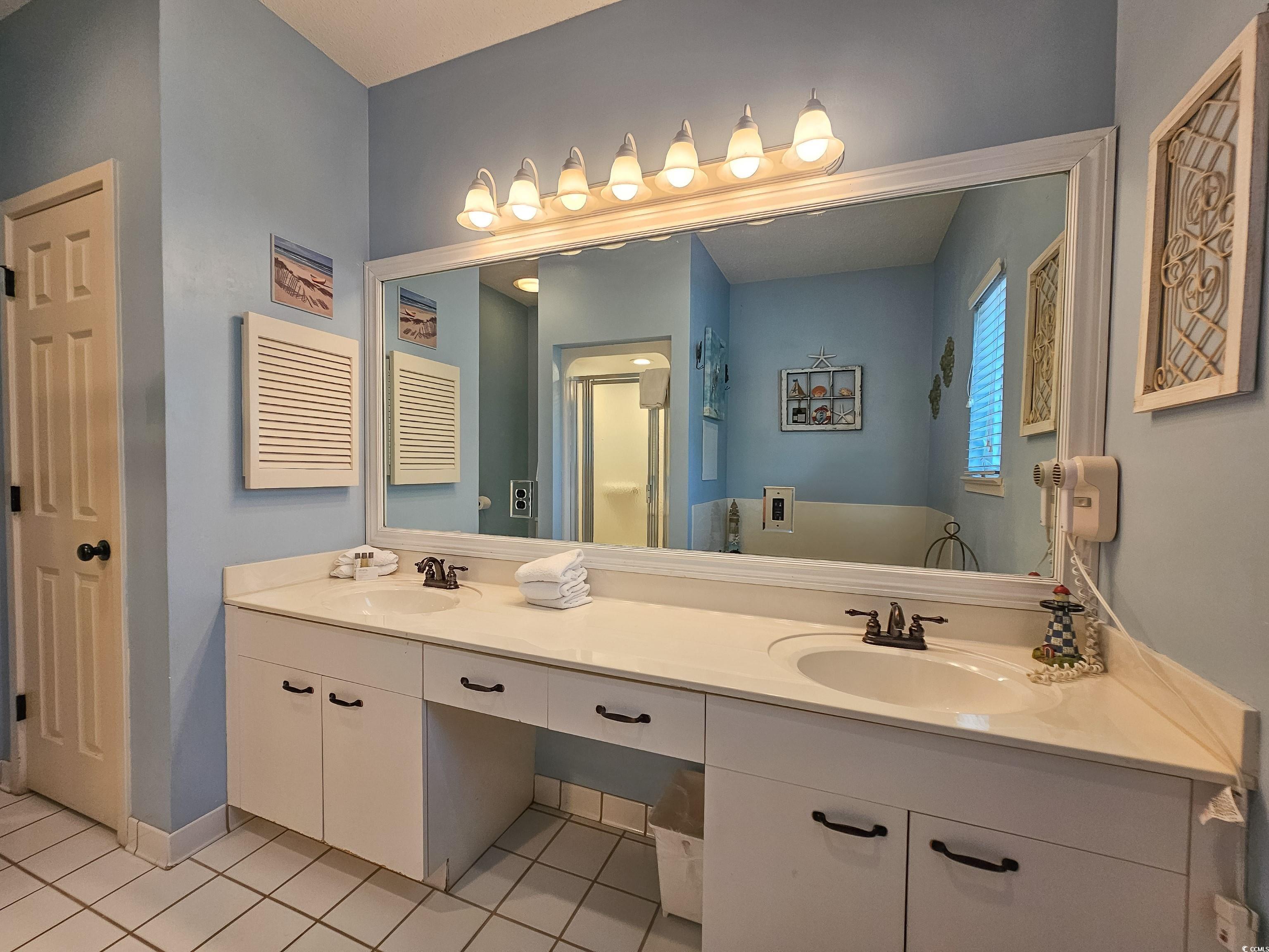 800 Castleford Circle, Unit 1E Myrtle Beach, SC 29572 - Photo 25 of 40 Full bath featuring tile patterned floors, double vanity, a sink, and baseboards