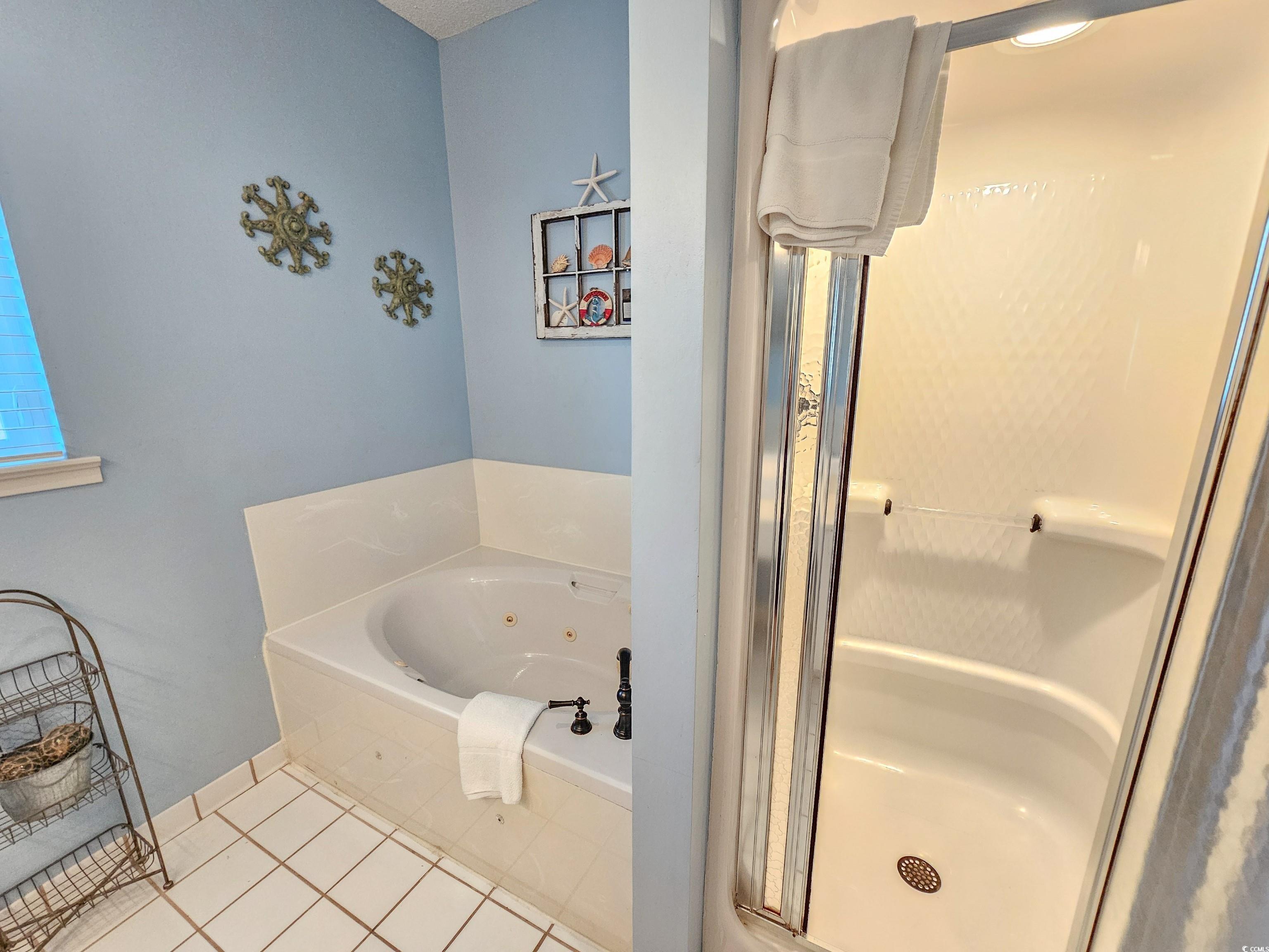 800 Castleford Circle, Unit 1E Myrtle Beach, SC 29572 - Photo 26 of 40 Bathroom with tile patterned floors, a jetted tub, and a shower stall