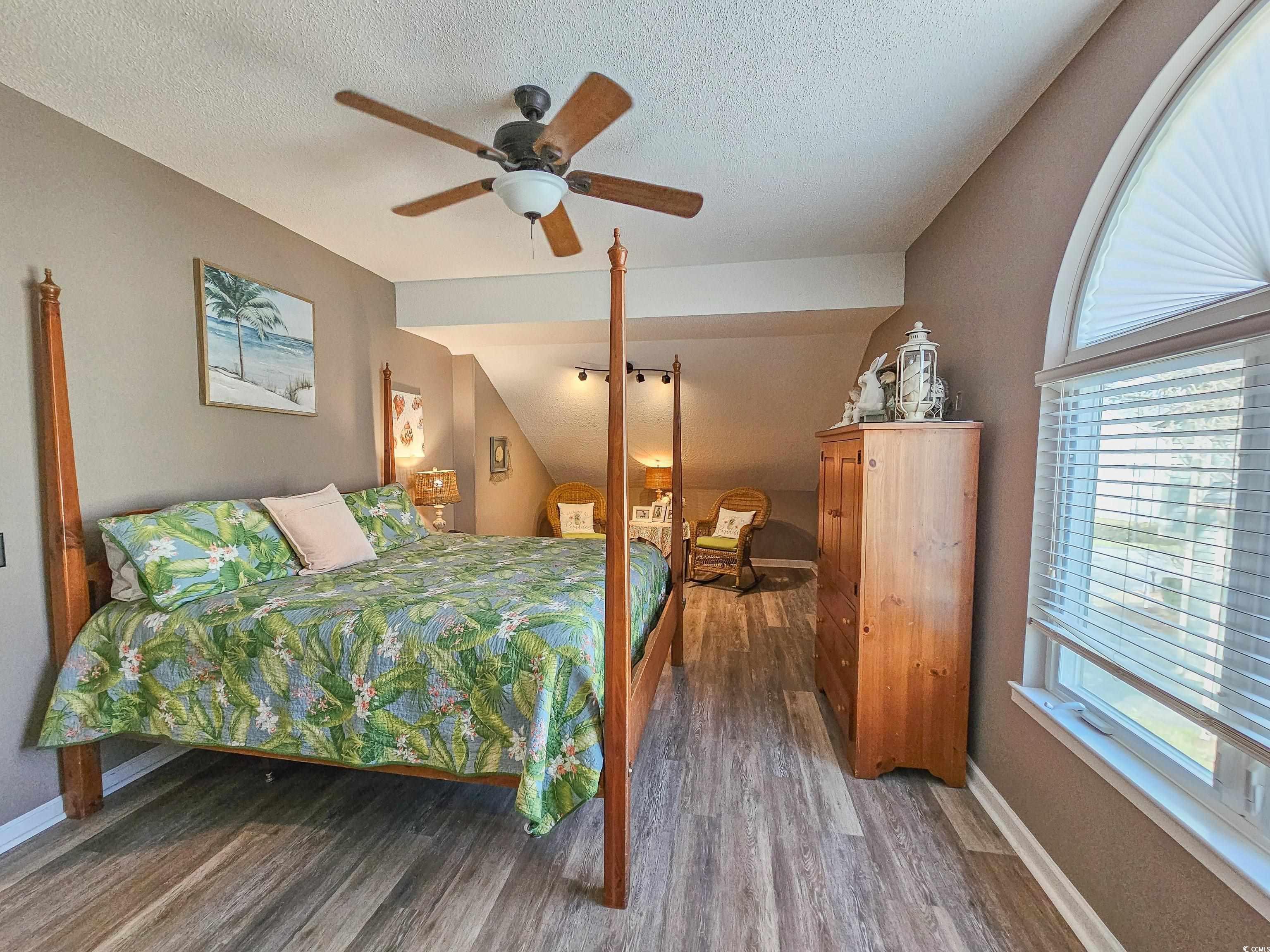 800 Castleford Circle, Unit 1E Myrtle Beach, SC 29572 - Photo 27 of 40 Bedroom featuring a ceiling fan, a textured ceiling, baseboards, and wood finished floors