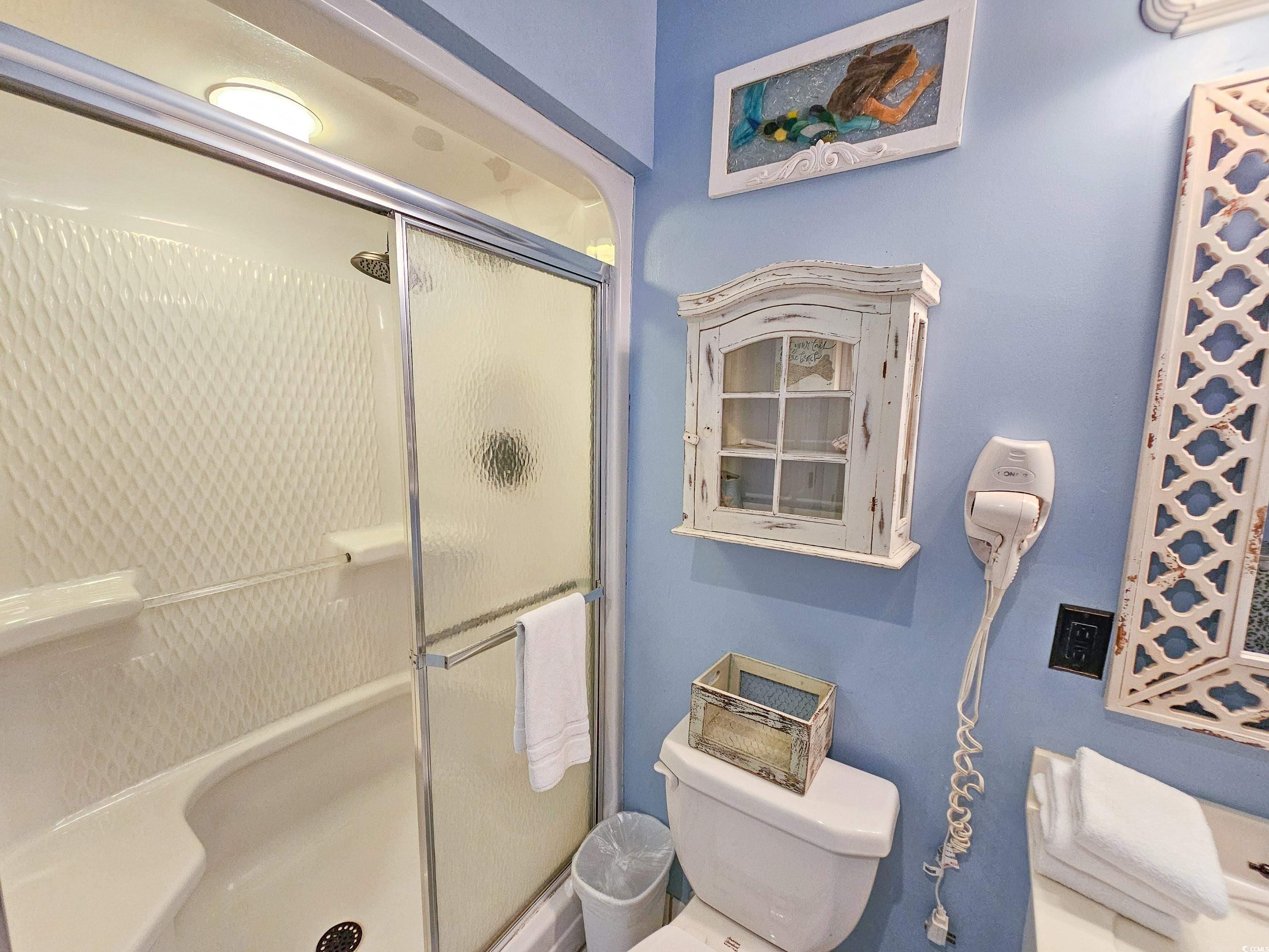 800 Castleford Circle, Unit 1E Myrtle Beach, SC 29572 - Photo 31 of 40 Bathroom featuring a stall shower and toilet