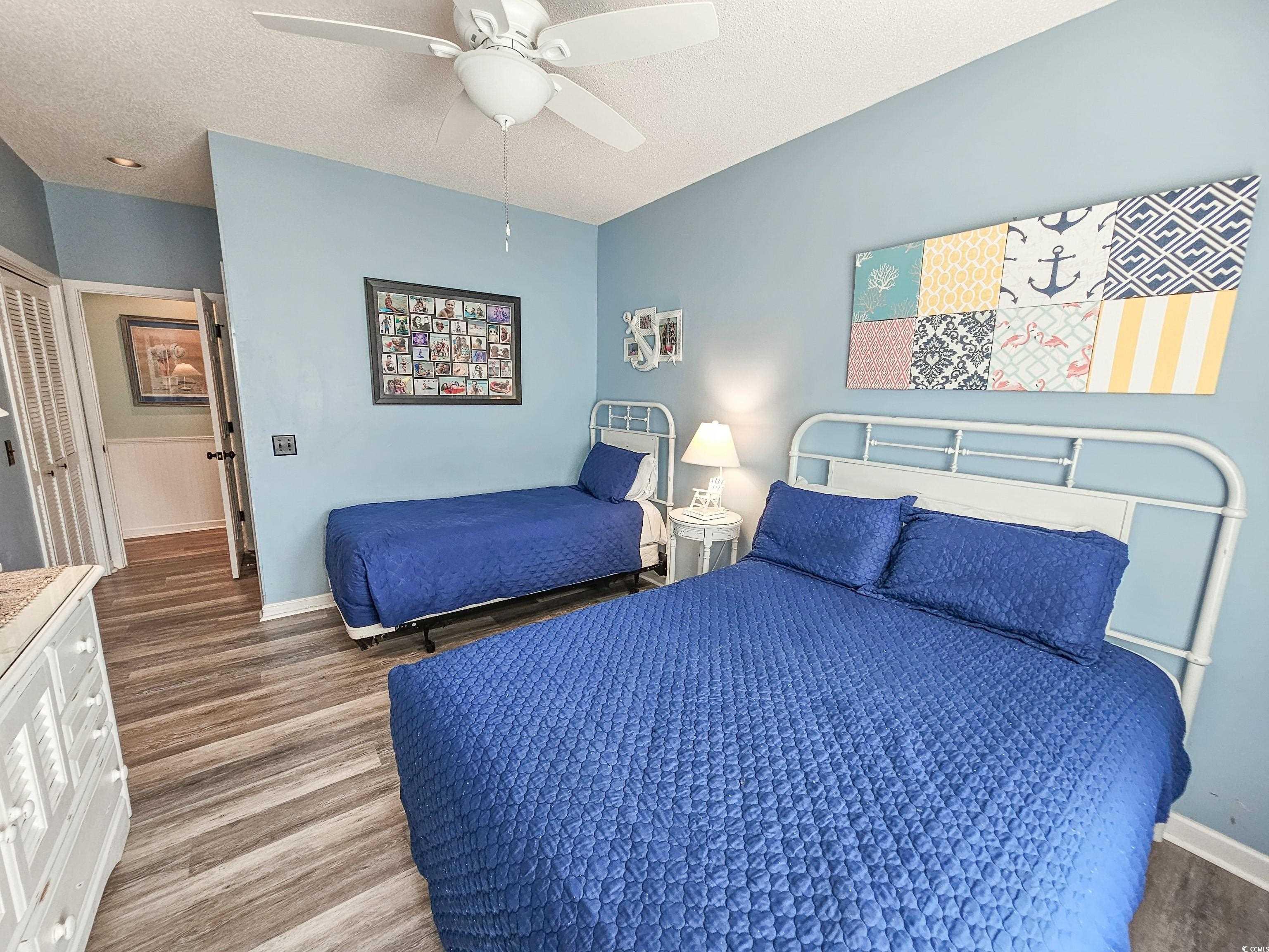 800 Castleford Circle, Unit 1E Myrtle Beach, SC 29572 - Photo 33 of 40 Bedroom with baseboards, a textured ceiling, wood finished floors, and a ceiling fan