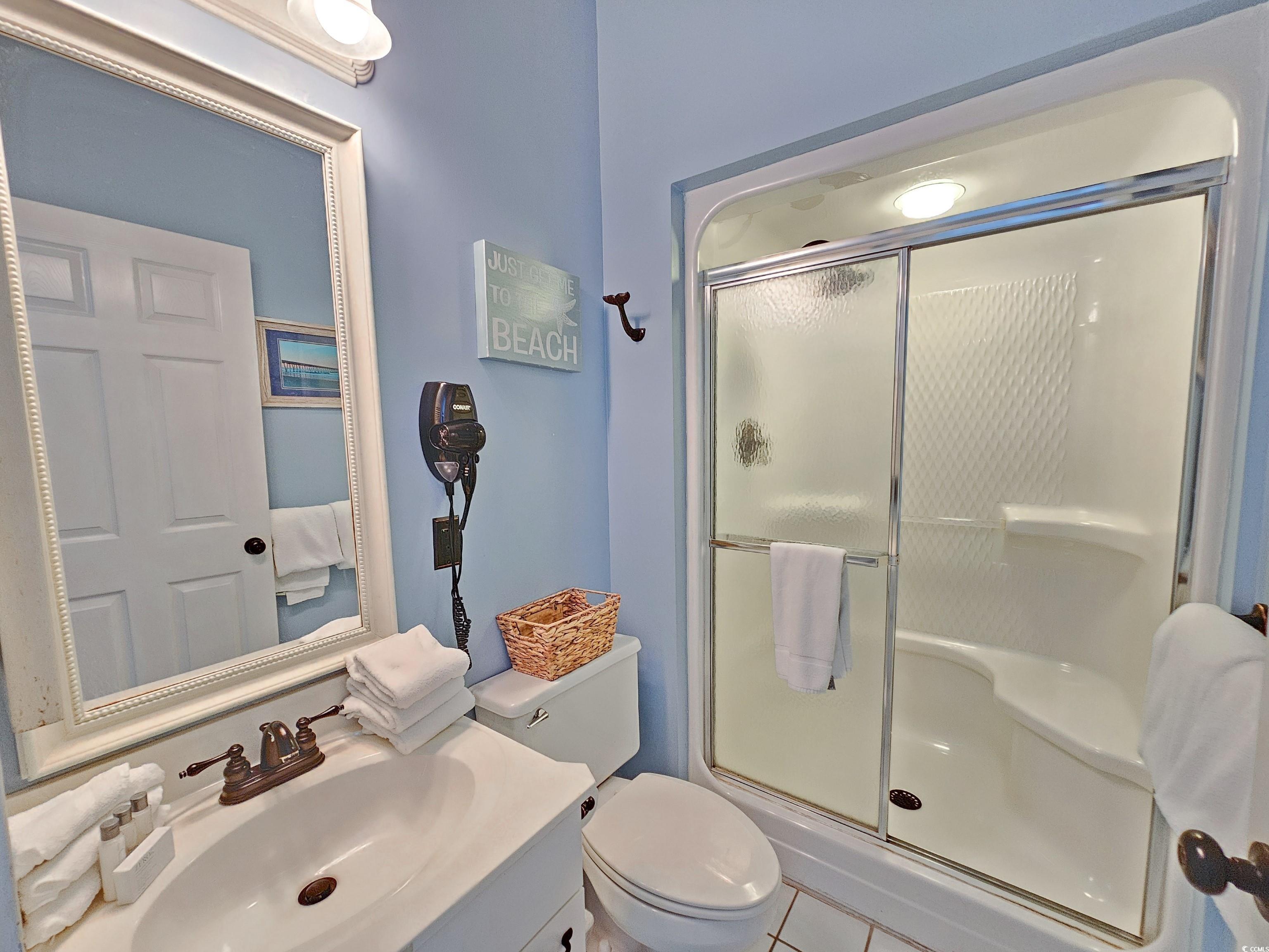 800 Castleford Circle, Unit 1E Myrtle Beach, SC 29572 - Photo 34 of 40 Bathroom with vanity, toilet, and a shower stall