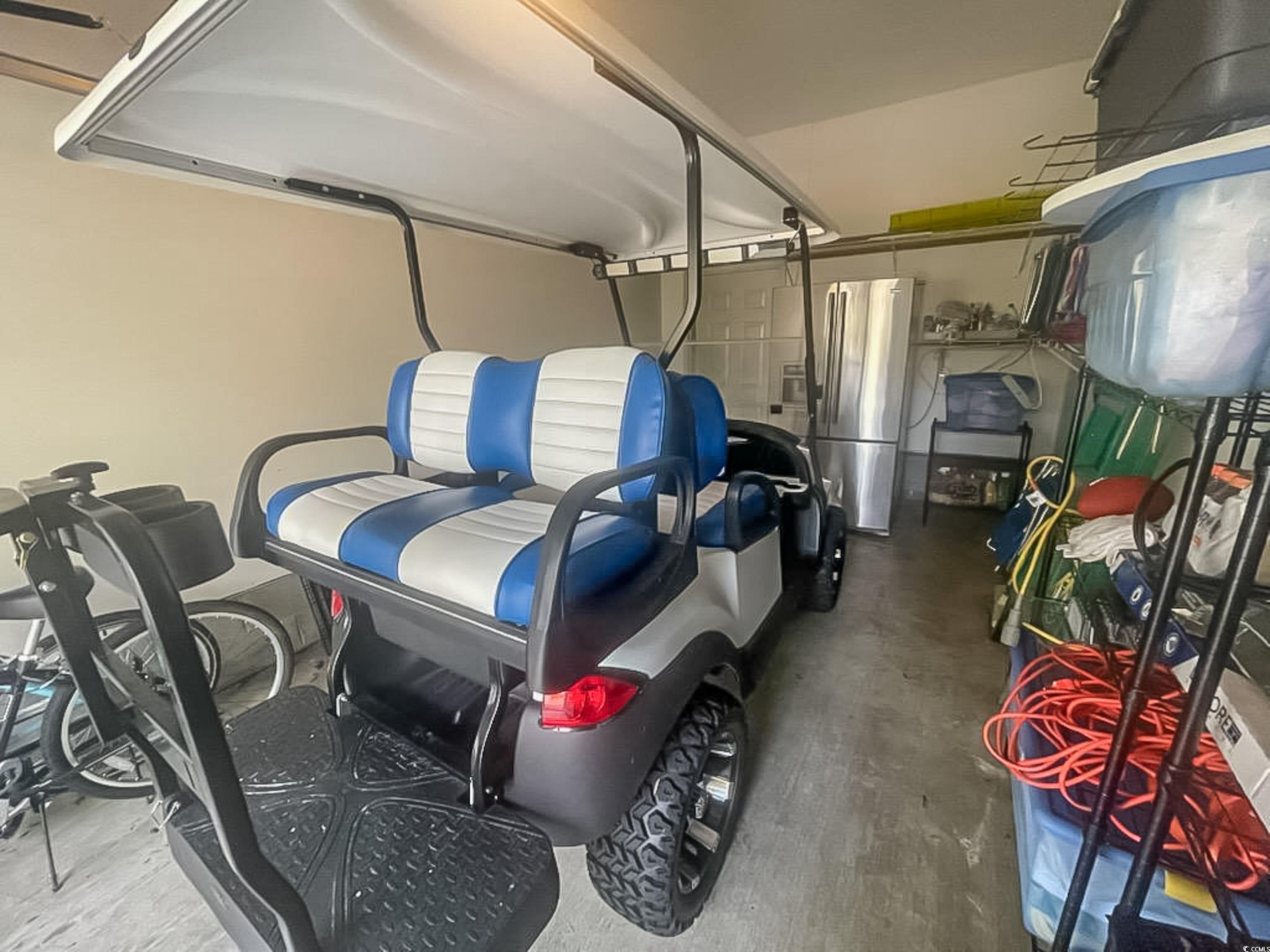 800 Castleford Circle, Unit 1E Myrtle Beach, SC 29572 - Photo 35 of 40 Garage with freestanding refrigerator