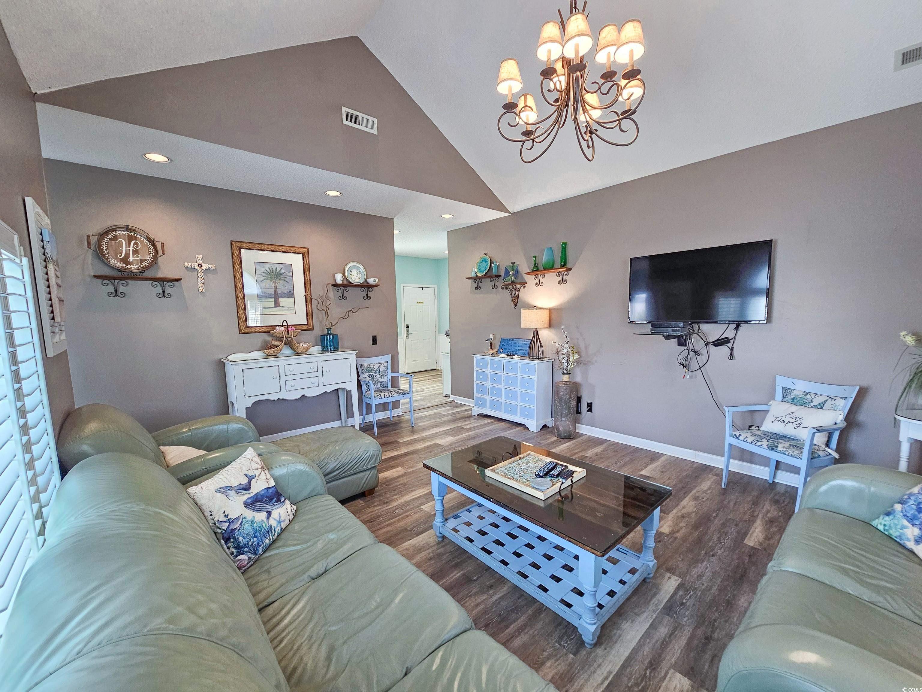 800 Castleford Circle, Unit 1E Myrtle Beach, SC 29572 - Photo 6 of 40 Living area featuring baseboards, visible vents, wood finished floors, and a chandelier