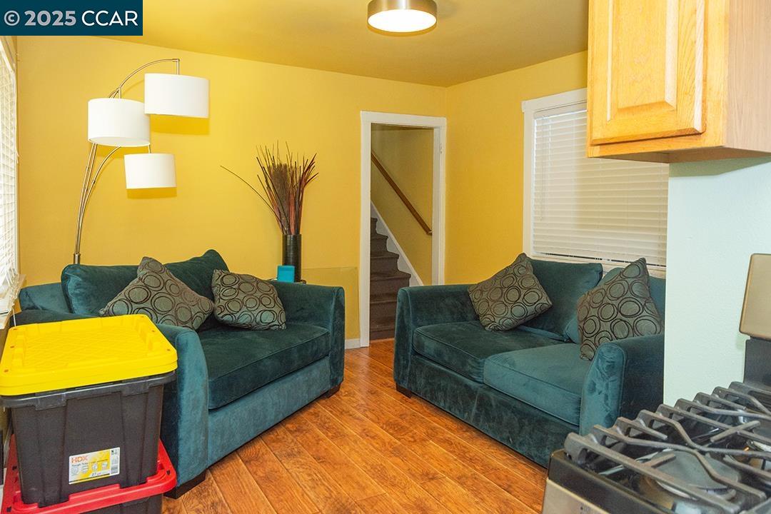 Melrose Heights Oakland, CA 94621 - Photo 27 of 34 a living room with furniture and a rug