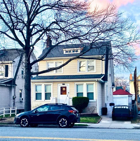 a car parked in front of a brick house